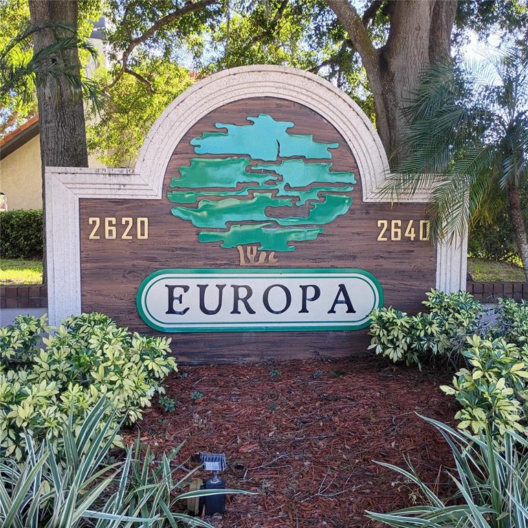 A wooden sign with the name Europa and the numbers 2620 and 2640 stands outdoors — 2632 ENTERPRISE ROAD E UNIT A12, CLEARWATER, FL
