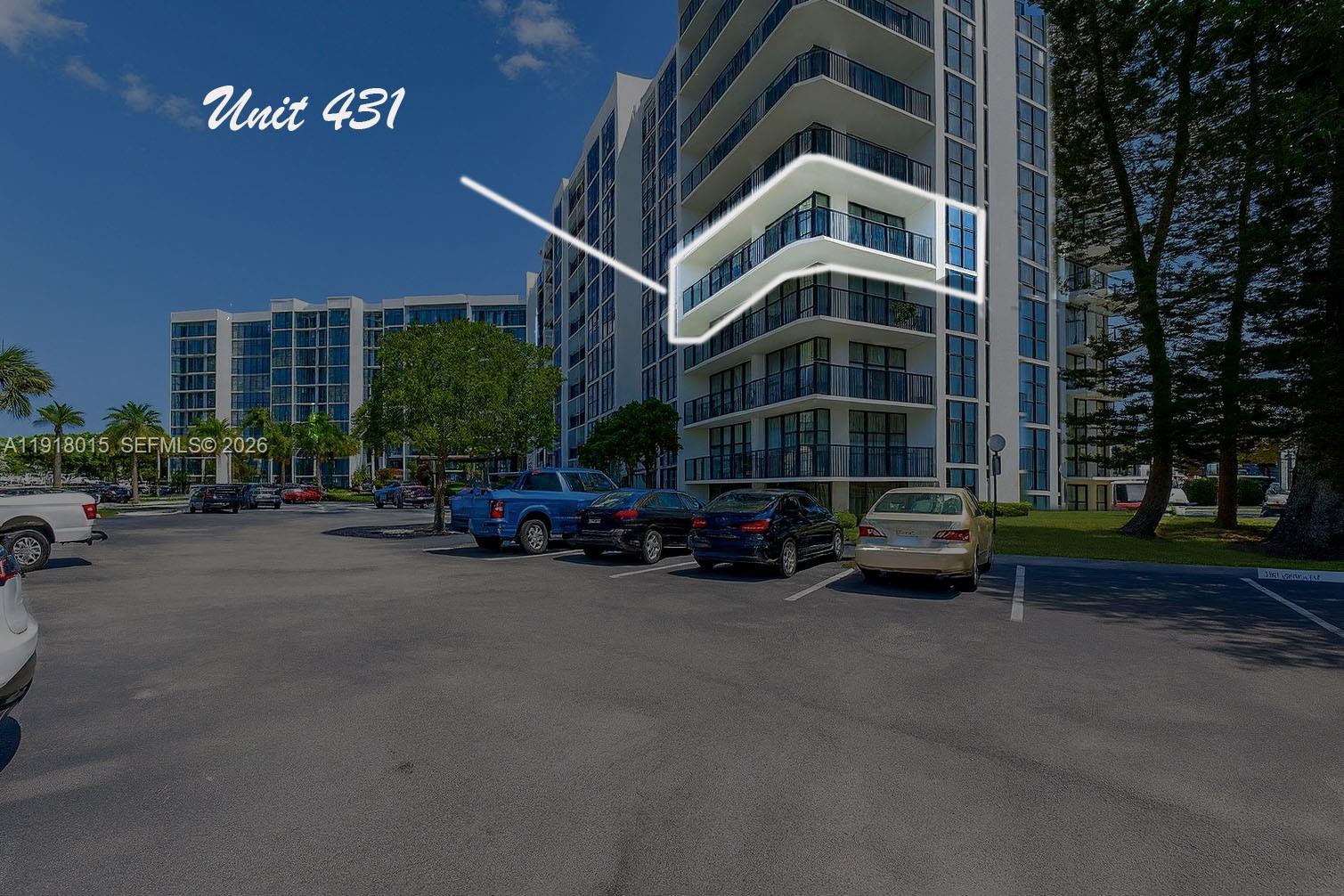 An exterior view of a multi-story apartment building highlighting a specific balcony on the fourth floor — 1000 Parkview Dr # 431, Hallandale Beach FL 33009, HALLANDALE BEACH, FL