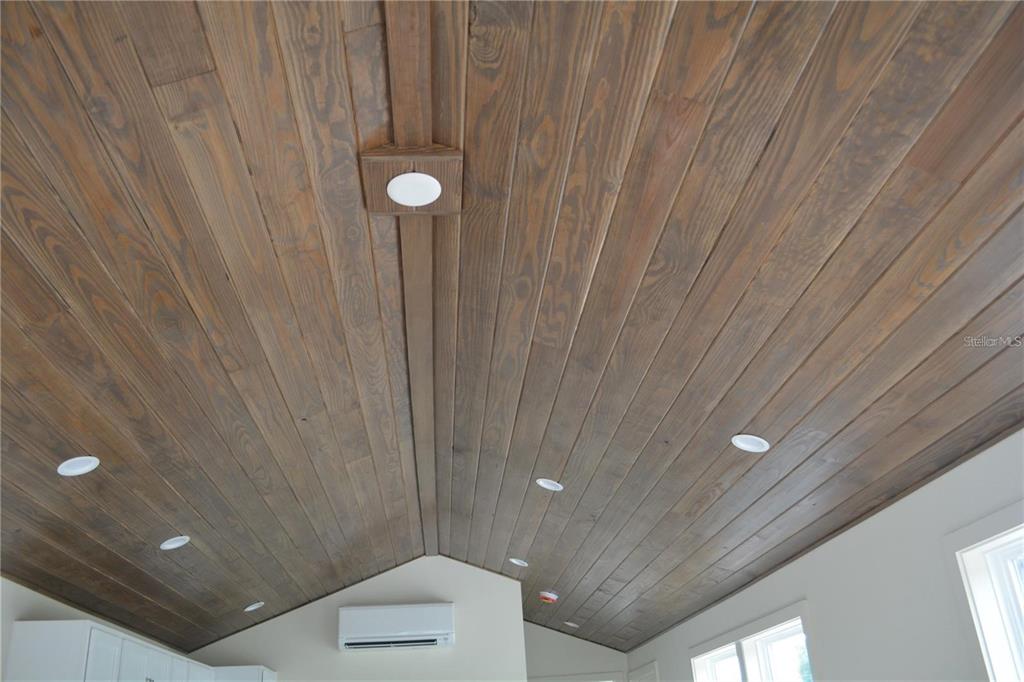 A vaulted ceiling features wood planking, recessed lighting, and a central light fixture — 620 THIRD STREET, OVIEDO, FL