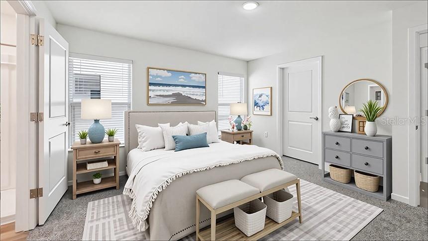 A bedroom features a bed with a light-colored comforter, a gray dresser, and two nightstands — 24317 NW 10TH ROAD, NEWBERRY, FL