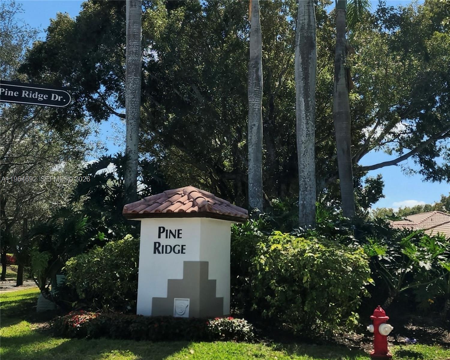A white monument sign with a tiled roof stands in front of trees and landscaping — 4309 Pine Ridge Ct, Weston FL 33331, WESTON, FL