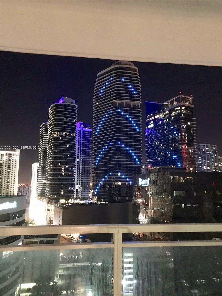 A night view of illuminated skyscrapers in a city skyline from a balcony — 950 Brickell Bay Dr # 2000, Miami FL 33131, MIAMI, FL