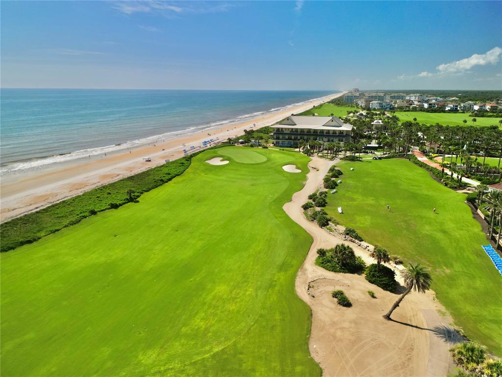 An aerial view of a golf course fairway bordering a sandy beach and the ocean — 200 OCEAN CREST DRIVE UNIT 408, PALM COAST, FL