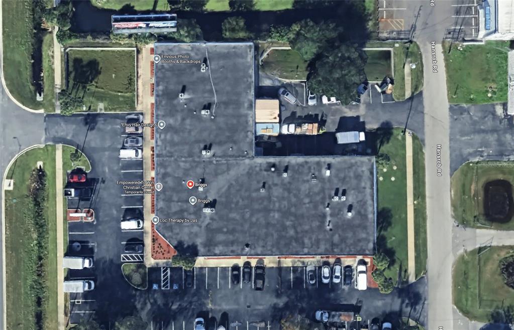 This is an aerial view of a commercial building with a parking lot — 3701 N JOHN YOUNG PARKWAY, ORLANDO, FL