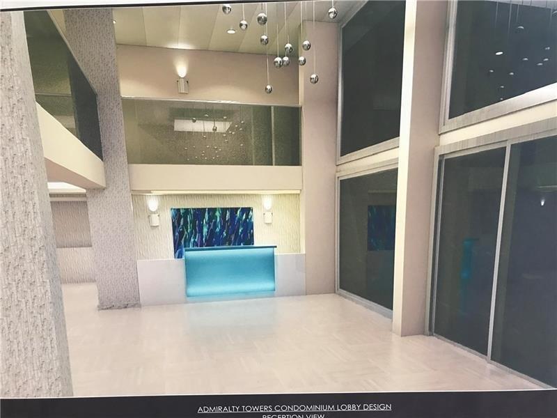 A rendering of a modern condominium lobby featuring a bright blue reception desk and pendant lighting — 750 N Ocean Boulevard # 1704, Pompano Beach FL 33062, POMPANO BEACH, FL