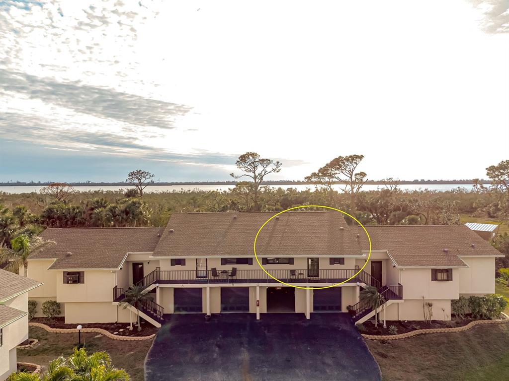 An aerial view of a two-story apartment building with a circled roof section — 4260 PLACIDA ROAD UNIT 12C, ENGLEWOOD, FL