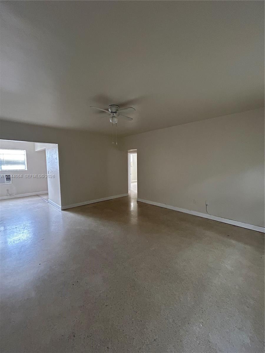 An empty room features a ceiling fan, light-colored walls, and a polished concrete floor — 730 83rd St # 2, Miami Beach FL 33141, MIAMI BEACH, FL