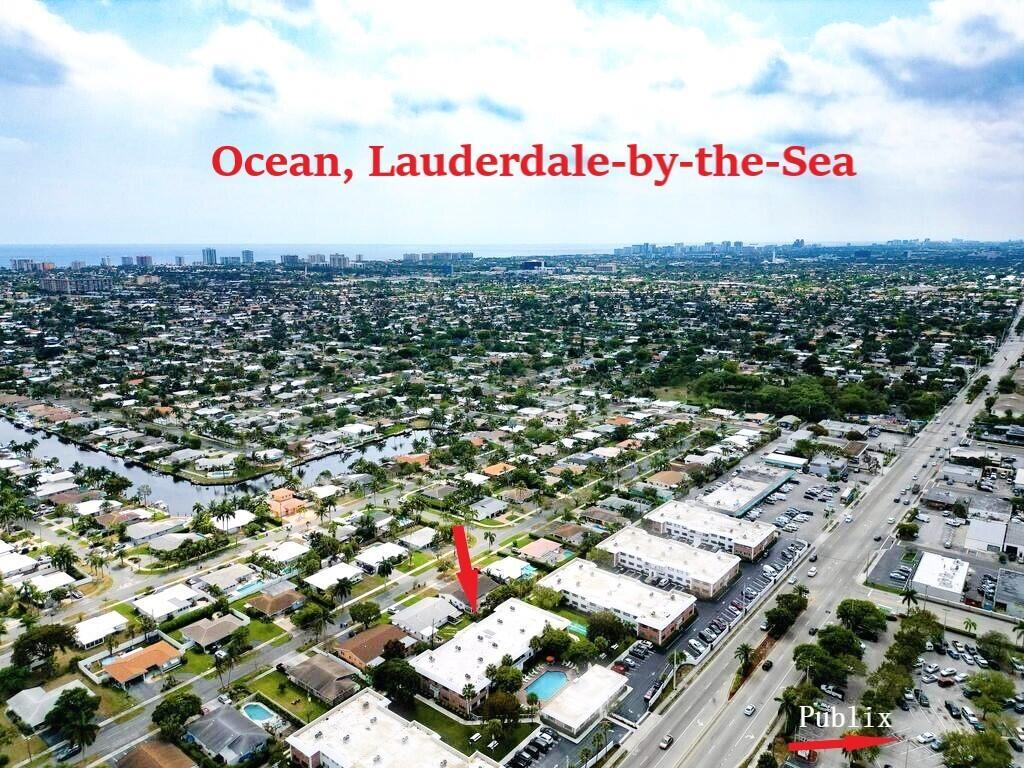 An aerial view shows a residential neighborhood in Lauderdale-by-the-Sea with a nearby Publix supermarket — 400 S Cypress Road # 404, Pompano Beach FL 33060, POMPANO BEACH, FL