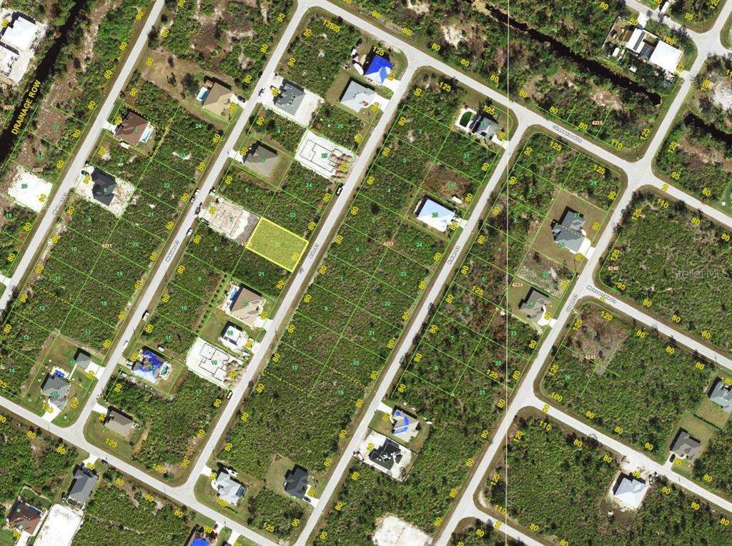 This is an aerial map showing a vacant residential lot highlighted in yellow — 8355 ADA STREET, PORT CHARLOTTE, FL