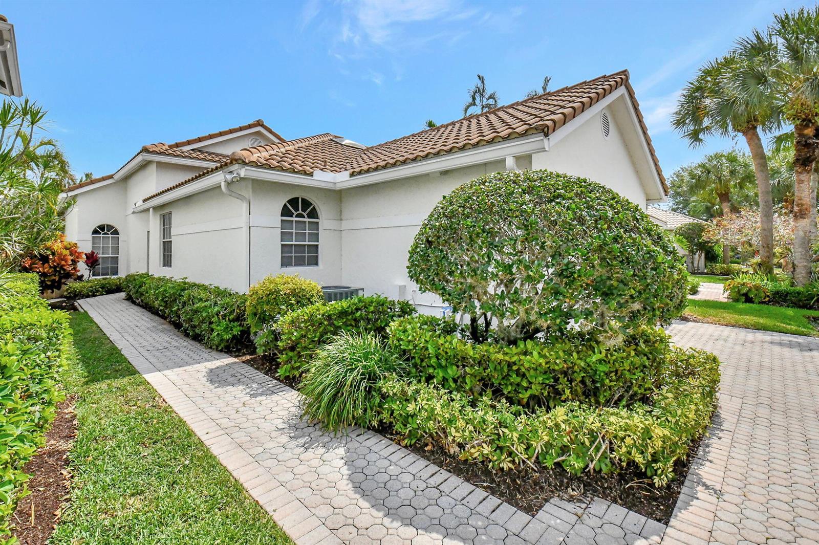 A white house with a tile roof, a paved walkway, and manicured landscaping — 2489 NW 66th Drive, Boca Raton FL 33496, BOCA RATON, FL