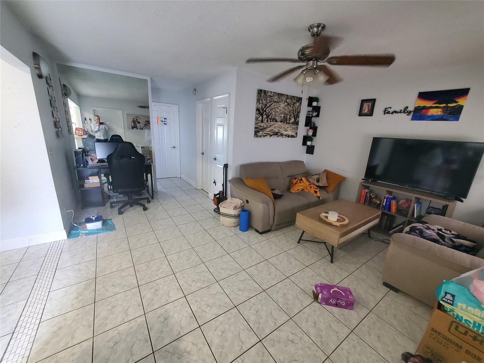 A living room with tile flooring, a ceiling fan, a sofa, and a television stand — 1021 NE 24th Avenue # 30, Pompano Beach FL 33062, POMPANO BEACH, FL