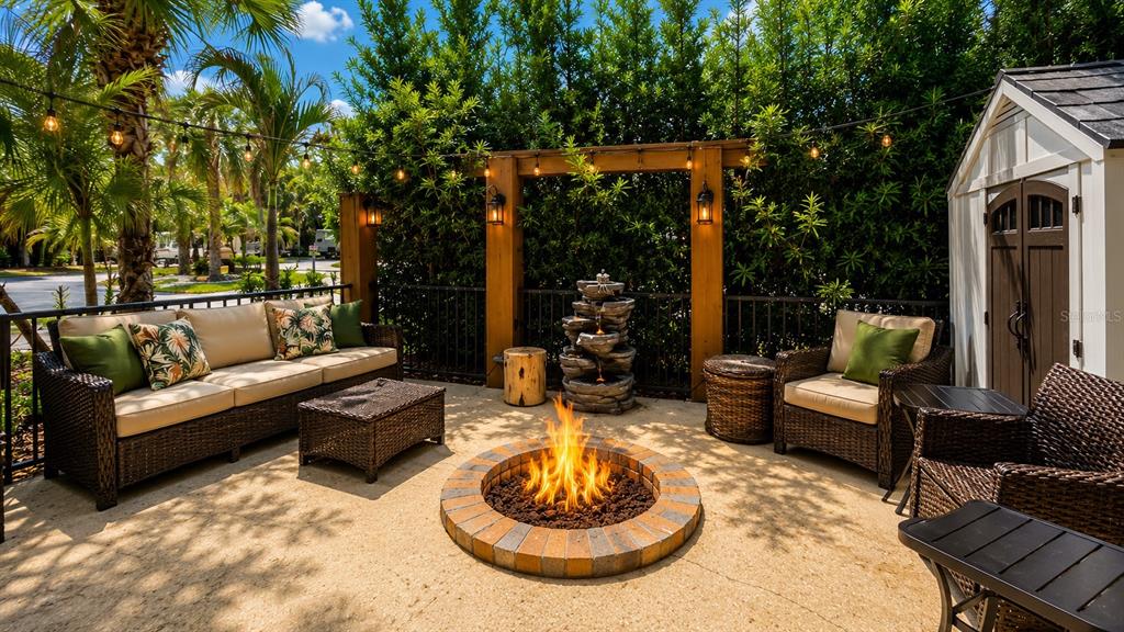 A patio features a fire pit, wicker seating, a water fountain, and a storage shed — 219 E APPALOOSA TRAIL, RIVER RANCH, FL