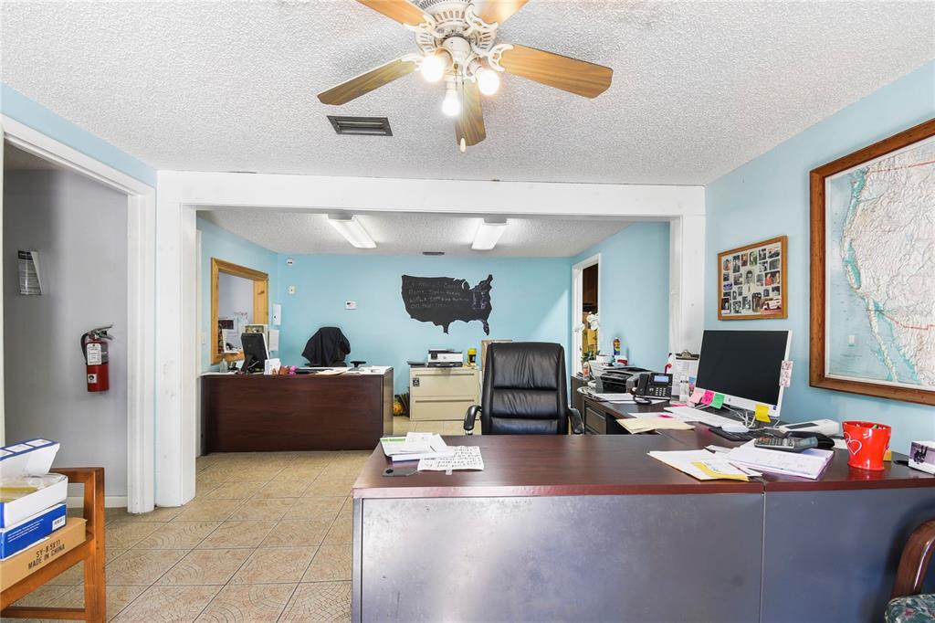 An office space features two desks, a ceiling fan, light blue walls, and tiled flooring — 1324 MATTIE STREET, ST AUGUSTINE, FL