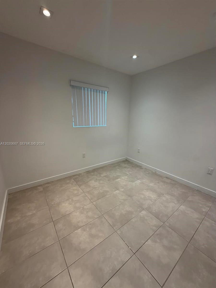 A small, empty room features light gray walls, recessed ceiling lights, and tiled flooring — 2333 SW 58th Ave # 2333, Miami FL 33155, MIAMI, FL