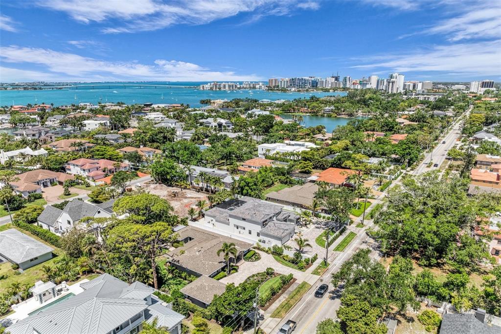 An aerial view shows a residential neighborhood with a modern house near a coastal bay — 1395 HARBOR DRIVE, SARASOTA, FL