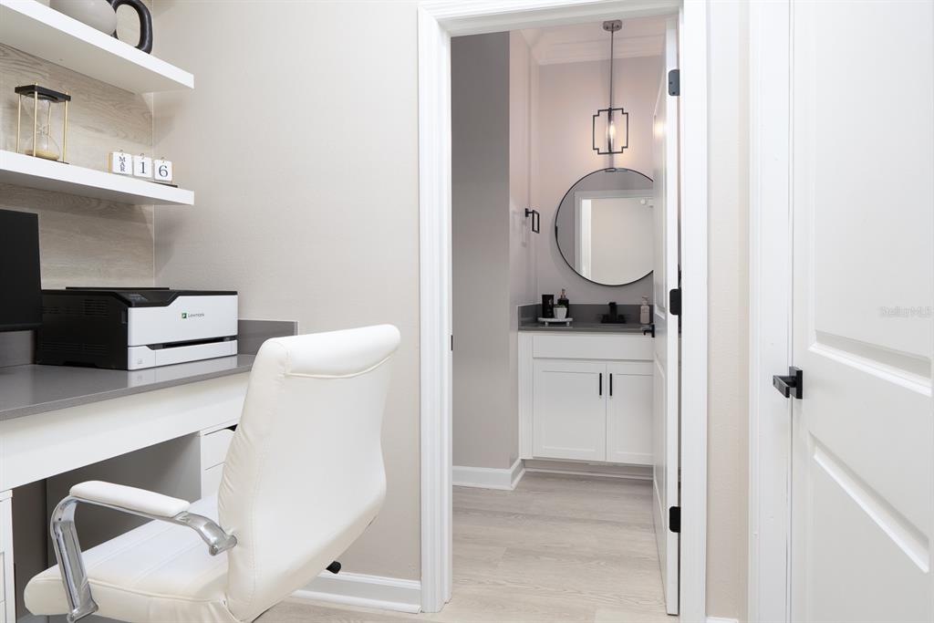 A home office with a desk and printer leads into a bathroom with a vanity — 3027 CAMDEN WAY, DAVENPORT, FL