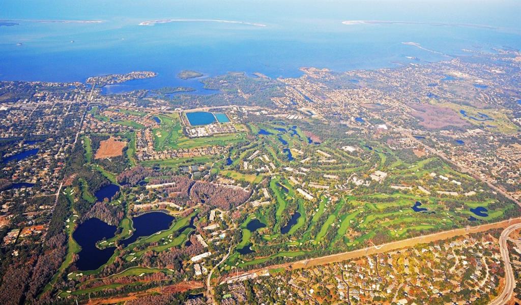 Aerial view of a residential community featuring a large golf course and several lakes — 1618 SANDHILL COURT, PALM HARBOR, FL