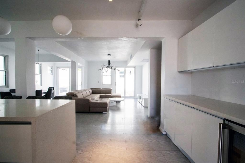 A modern, open-concept kitchen and living area with white cabinetry and light-colored tile flooring — 2071 CACIQUE STREET, SAN JUAN, PR