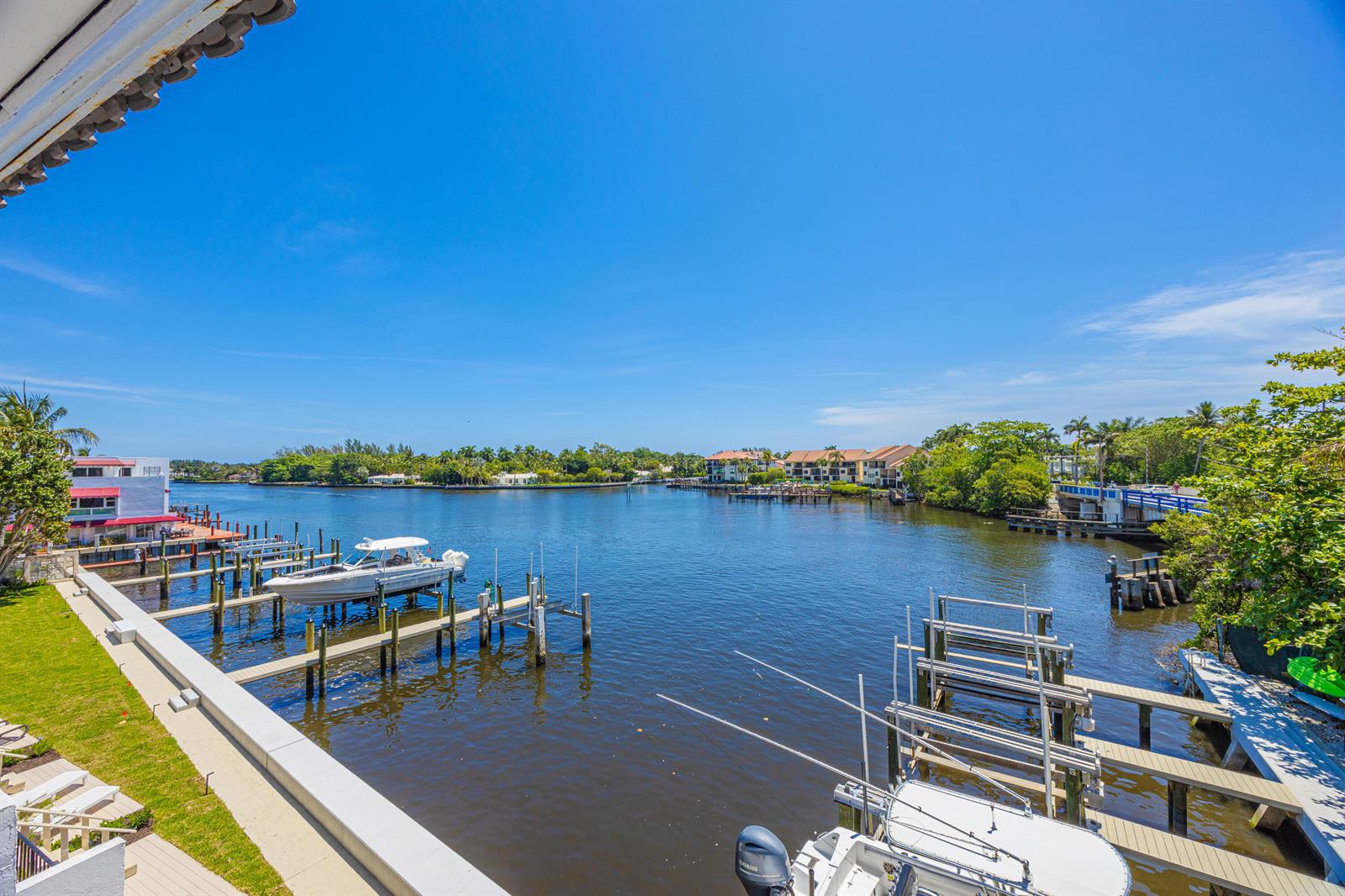 A view of a canal with boat docks and lifts from an elevated balcony — 801 Palm Trail # 9, Delray Beach FL 33483, DELRAY BEACH, FL