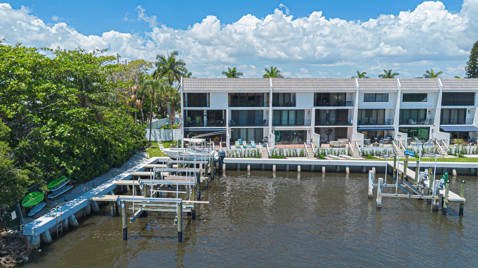 An aerial view shows a multi-story waterfront townhouse complex with private boat docks and slips — 801 Palm Trail # 9, Delray Beach FL 33483, DELRAY BEACH, FL