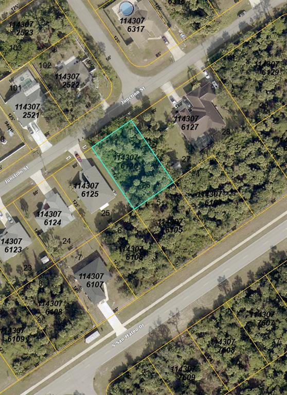 This is an aerial map showing a vacant lot highlighted in blue among residential properties — JUNCTION STREET, NORTH PORT, FL