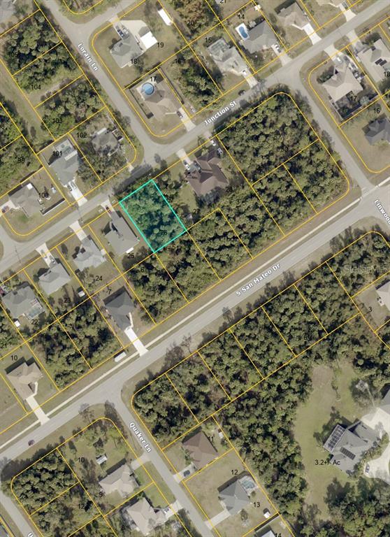 This is an aerial map showing a vacant residential lot highlighted in blue — JUNCTION STREET, NORTH PORT, FL