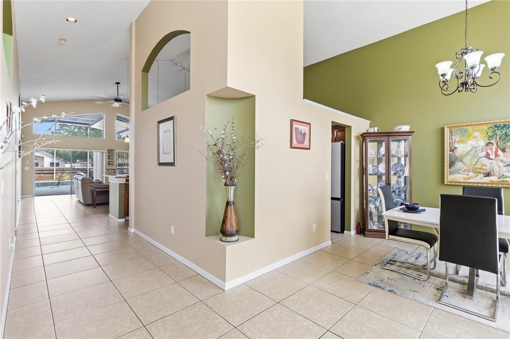 A dining area with a green accent wall, tile flooring, and a central display niche — 265 KASSIK CIRCLE, ORLANDO, FL