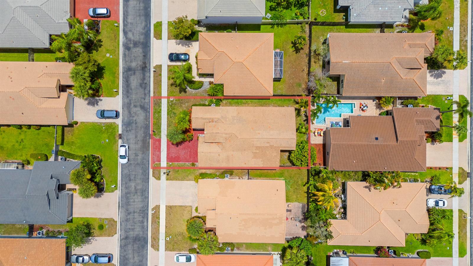 An aerial view shows a residential house with a tan roof and a red-mulched front yard — 10720 Oak Bend Way, Wellington FL 33414, WELLINGTON, FL
