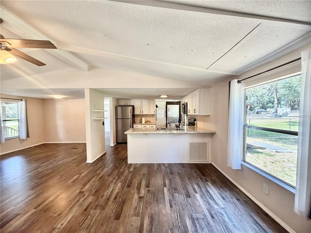 A single-story manufactured home with a metal roof and front porch sits on a lawn — 6655 NW 49TH COURT, OCALA, FL