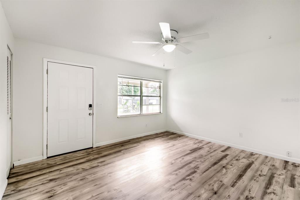 A room with white walls, a ceiling fan, a window, and wood-look flooring — 2715 RAMSEY DR, APOPKA, FL