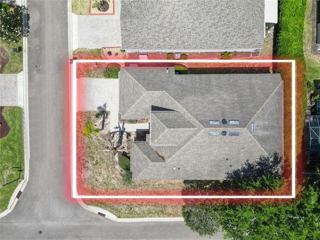 An aerial view shows a house with a shingled roof and a fenced-in yard — 500 ARENA DRIVE, DAVENPORT, FL