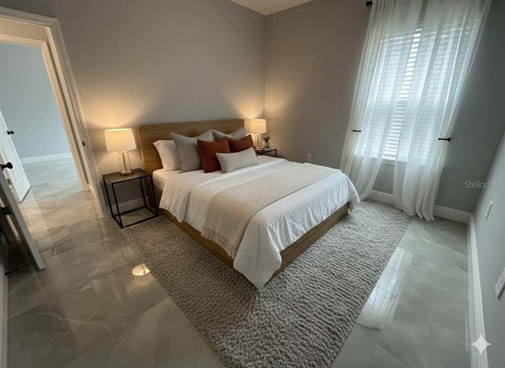 A bedroom features a wooden bed frame, a gray area rug, and tile flooring — 373 AMBERJACK COURT, KISSIMMEE, FL