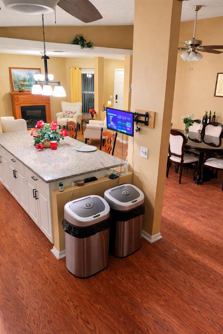 A living room features four white armchairs arranged around a small table and fireplace — 6794 Picante Circle, Fort Pierce FL 34951, FORT PIERCE, FL