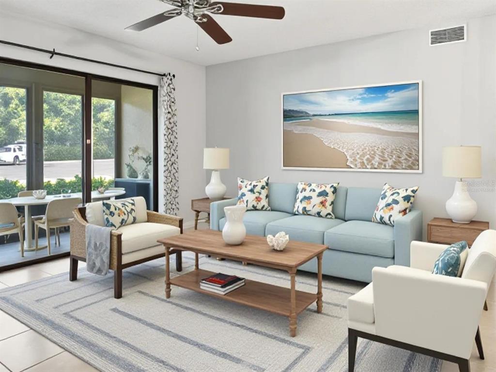 A living room features a light blue sofa, two armchairs, a coffee table, and beach artwork — 3101 LAKE PINE WAY UNIT A1, TARPON SPRINGS, FL
