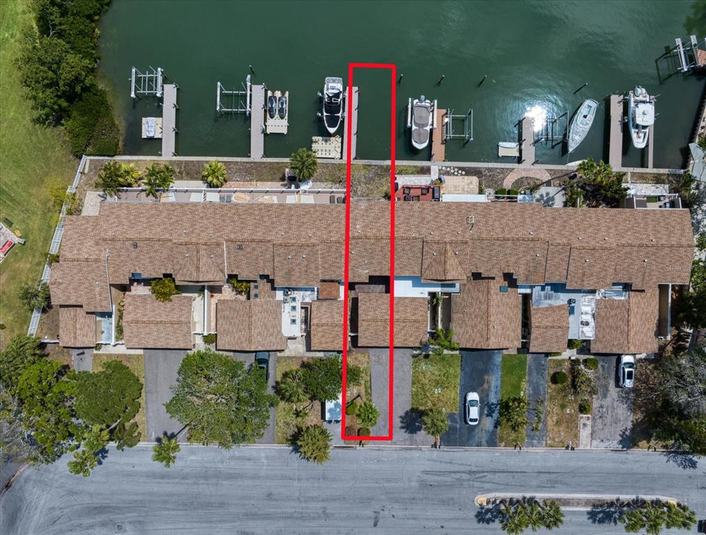 An aerial view shows a townhouse unit highlighted in red with a private boat slip — 829 E GULF BOULEVARD UNIT 107, INDIAN ROCKS BEACH, FL
