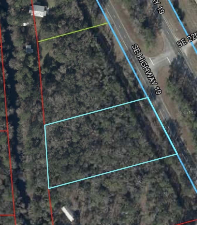 This aerial map shows a rectangular plot of land outlined in blue near a highway — 0 SE HWY 19, INGLIS, FL