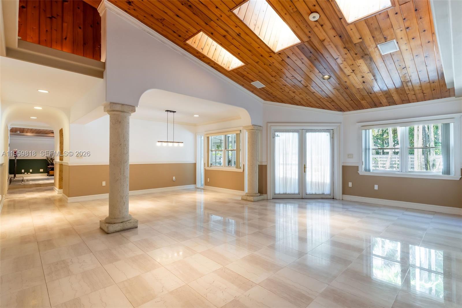 A swimming pool with a rock waterfall feature is surrounded by a stone patio — 15005 SW 148th St, Miami FL 33196, MIAMI, FL