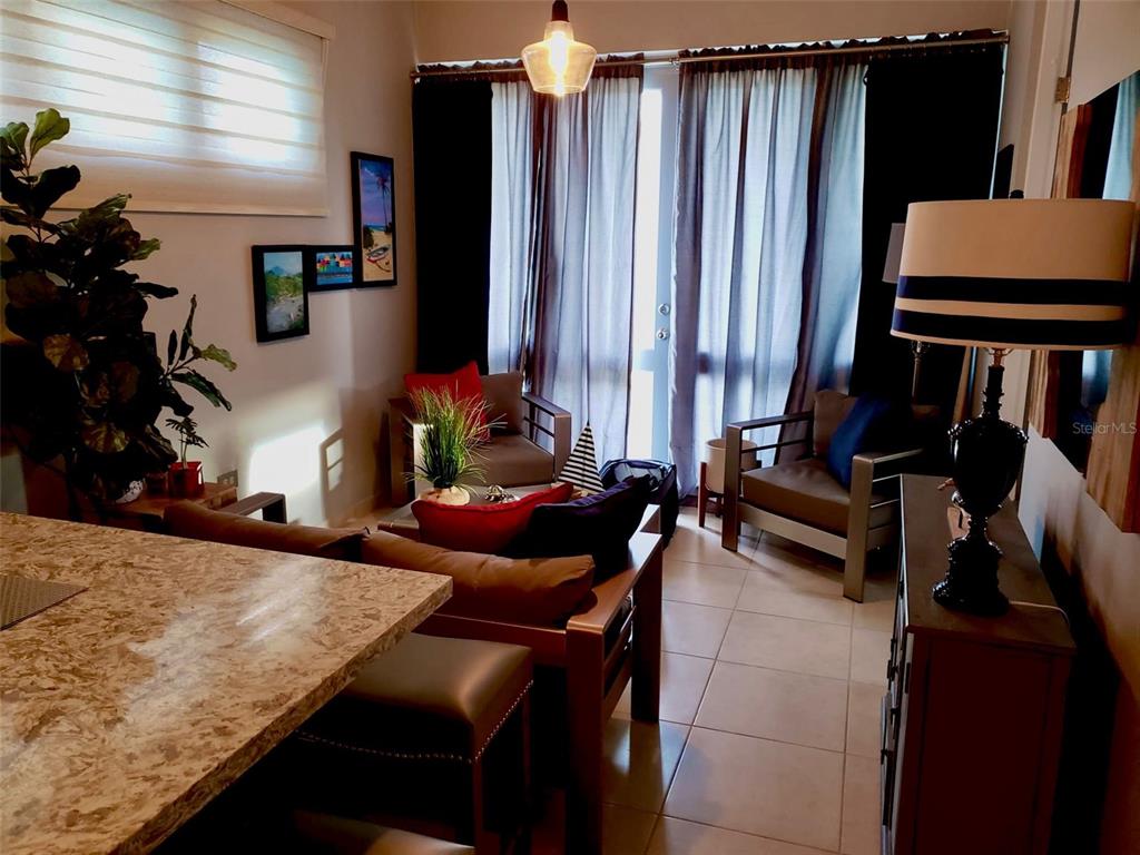 A living room features a stone-topped counter, two armchairs, and a sliding glass door — Carr. PR 307 km 8.5 BOQUERÓN BAY SIDE INC APT #23, CABO ROJO, PR