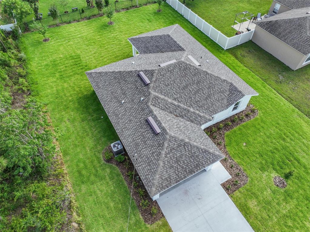 An aerial view shows a single-story house with a shingled roof and a concrete driveway — 134 RED MILL DRIVE, PALM COAST, FL