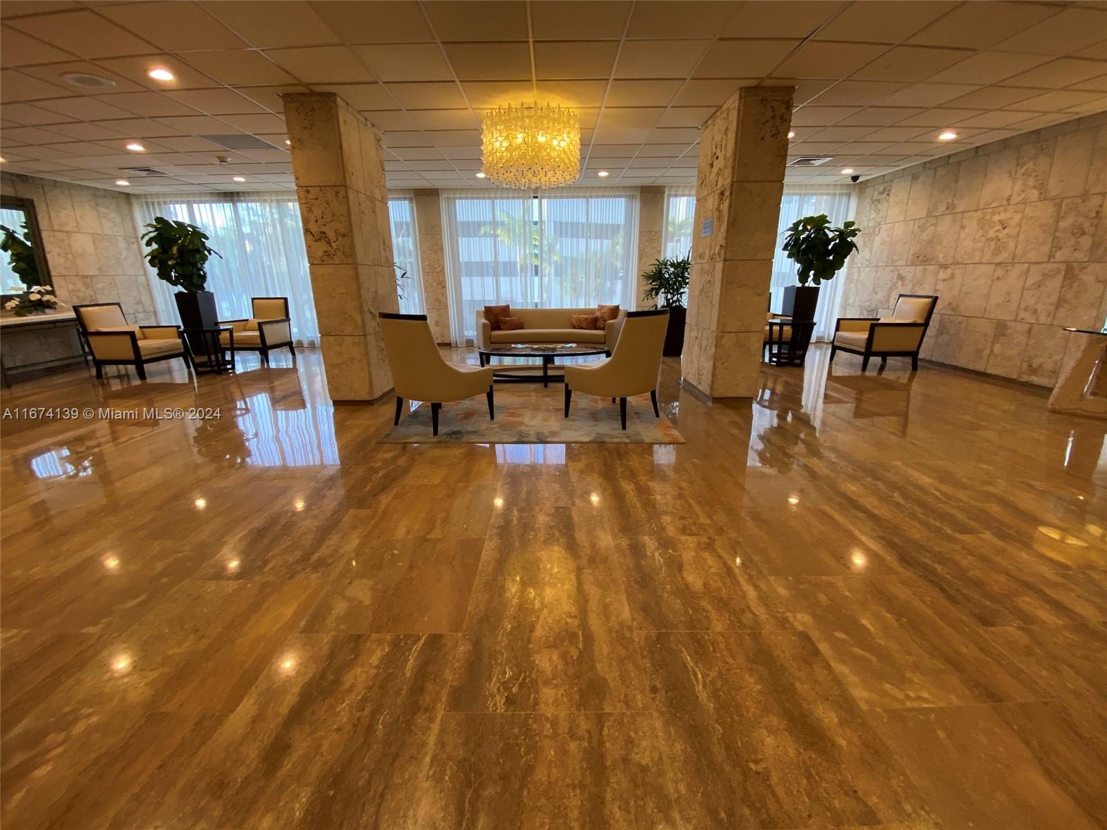 A lobby features polished stone floors, two large stone columns, and several seating areas — 1965 S Ocean Dr # 4D, Hallandale Beach FL 33009, HALLANDALE BEACH, FL
