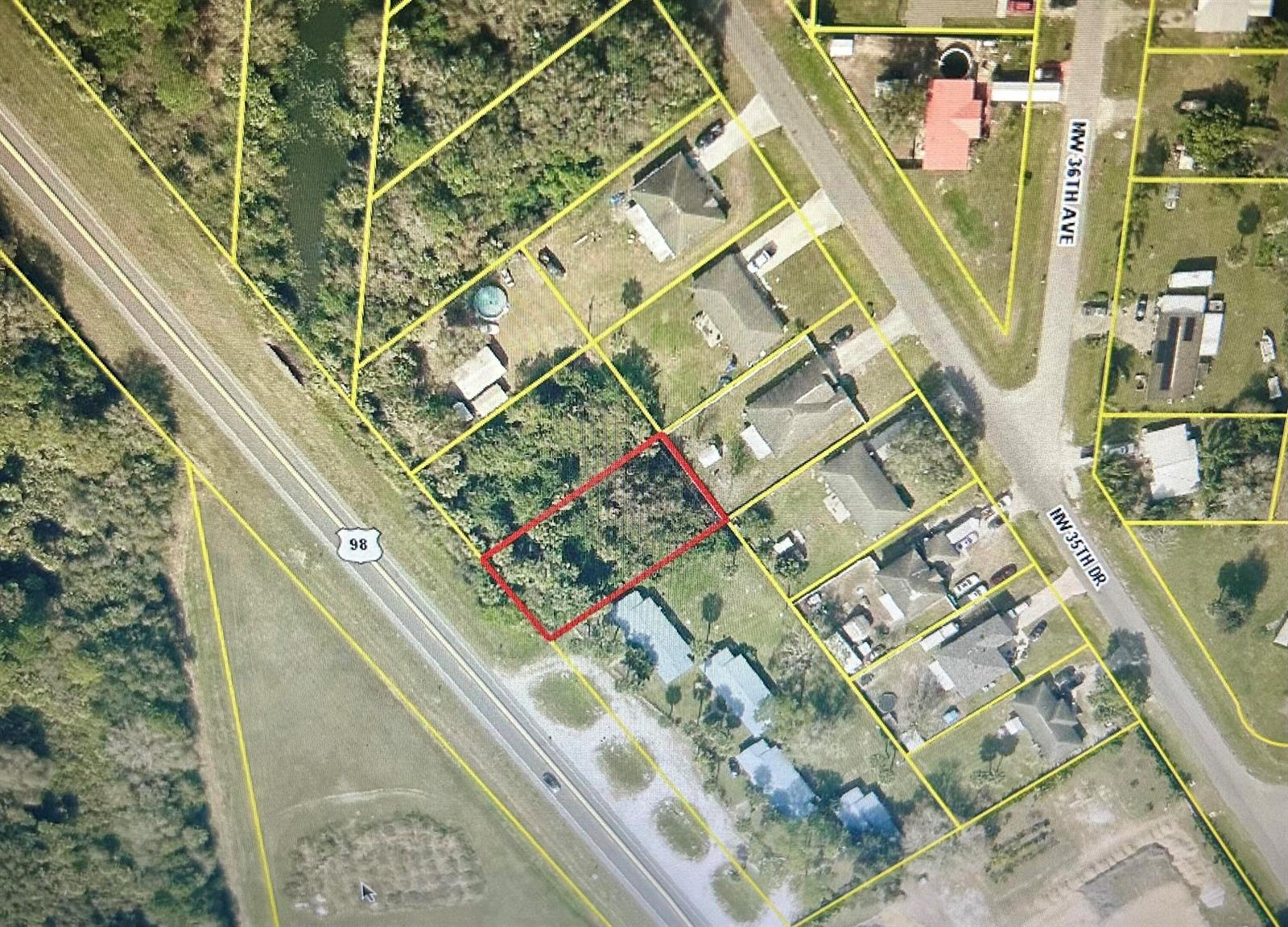 An aerial map view shows a rectangular vacant lot outlined in red near a highway — 2640 Hwy 98 N, FL 34972, FL