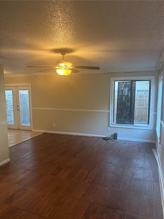 An empty room with wood-look tile flooring, a ceiling fan, and a large window — 1320 MOUNTAINVIEW UNIT 1320, TAMPA, FL
