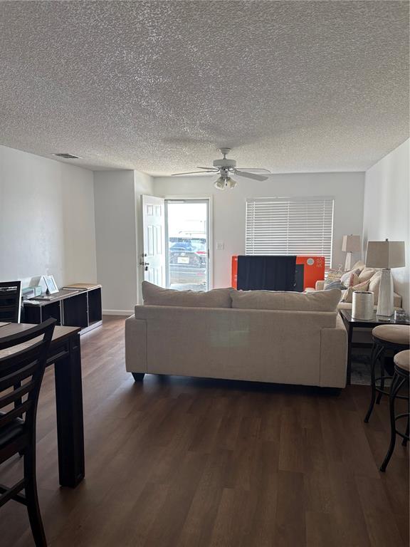 A living room features light-colored furniture, wood-look flooring, a ceiling fan, and an open doorway — 60 WINTER RIDGE ROAD UNIT 60, WINTER HAVEN, FL