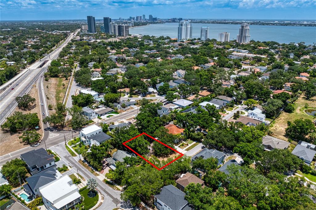 An aerial view shows a vacant residential lot outlined in red within a suburban neighborhood — 3403 W BAY VILLA AVENUE, TAMPA, FL