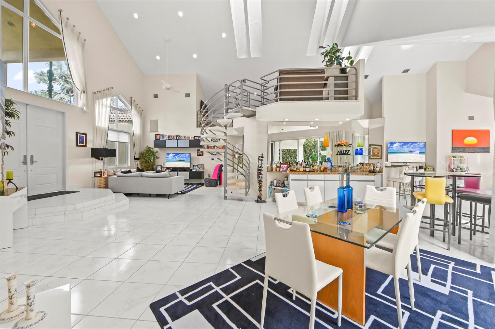 A spacious living and dining area features white tile floors, a spiral staircase, and loft — 7165 Mariana Court, Boca Raton FL 33433, BOCA RATON, FL