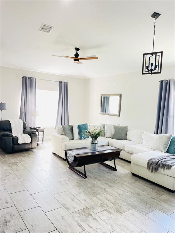 A backyard patio features a hot tub under a wooden gazebo and a screened-in porch — 3485 MIDDLEBROOK PLACE, HARMONY, FL
