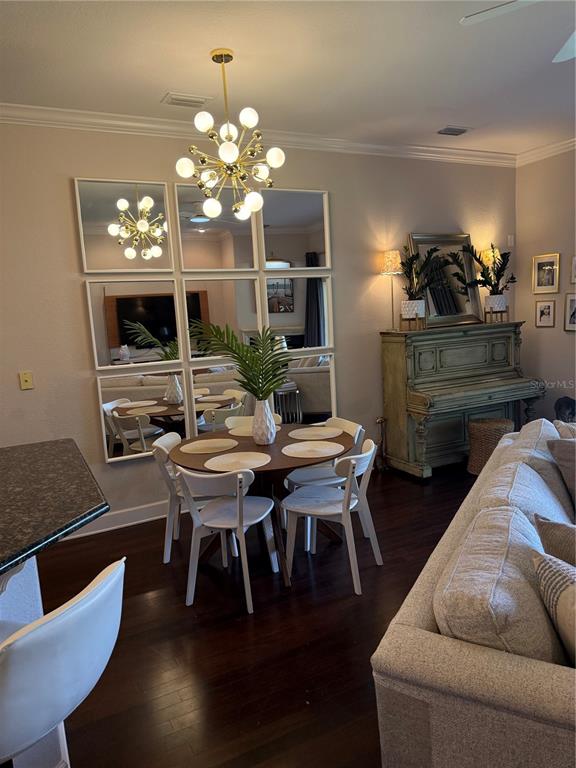A kitchen with light gray cabinets and dark countertops overlooks a living room with sofa — 1018 GREEN GATE BOULEVARD, GROVELAND, FL