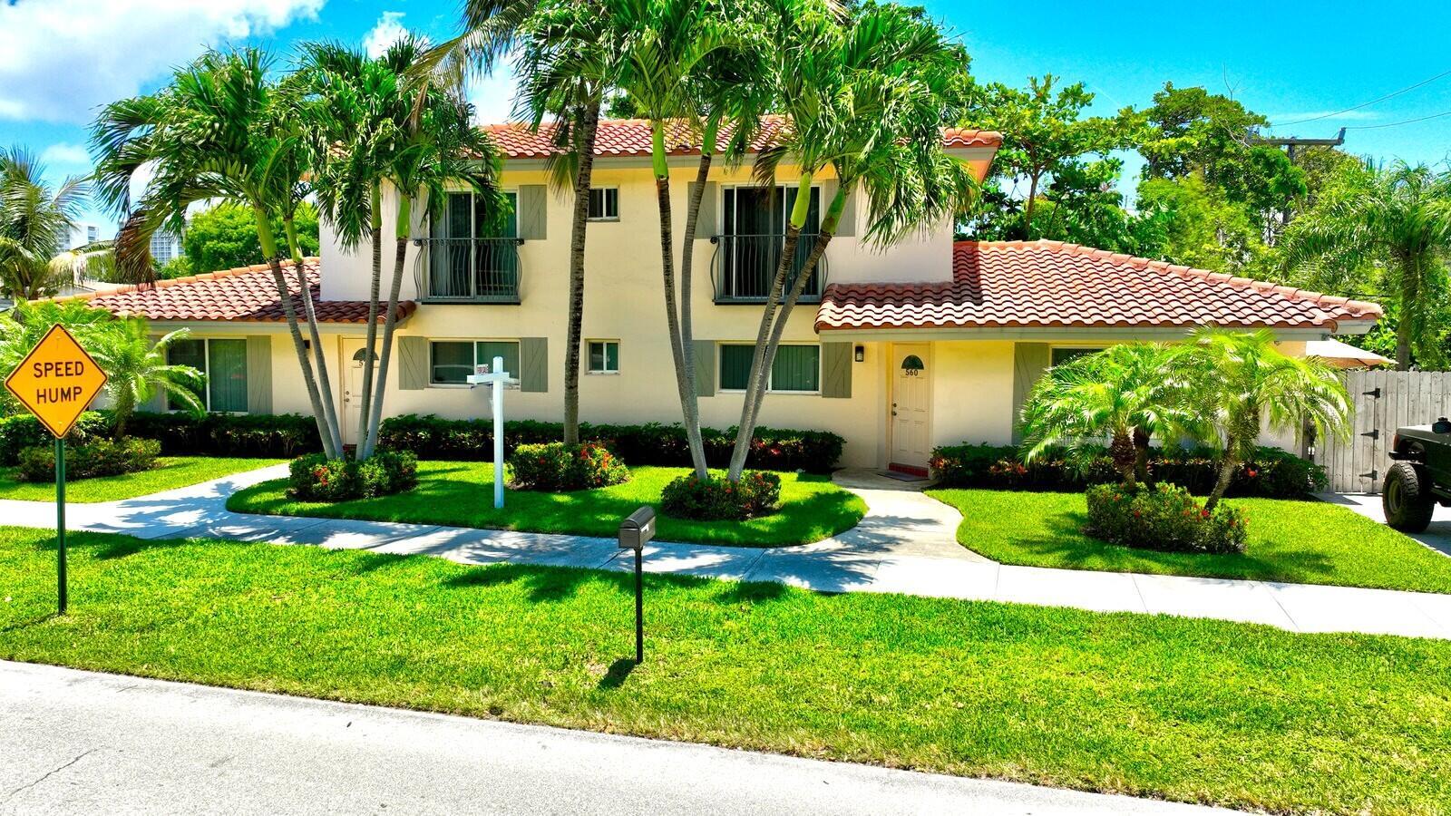 A two-story house with a red tile roof, palm trees, and a yellow exterior — 560-570 NE 19th Avenue, Deerfield Beach FL 33441, DEERFIELD BEACH, FL