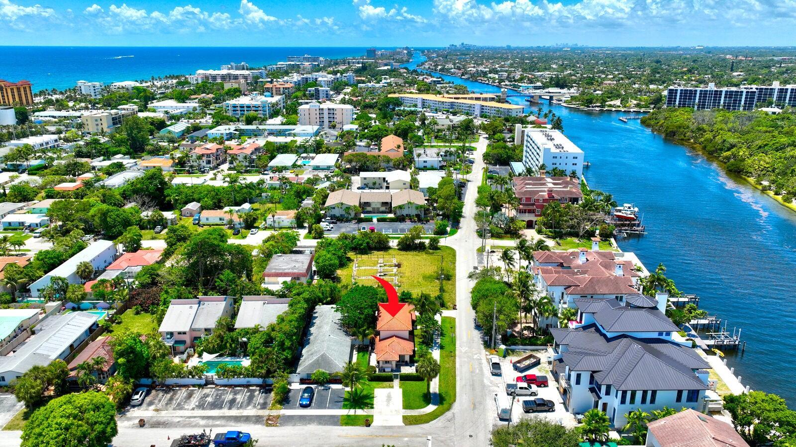 An aerial view shows a residential house with a red-tiled roof near a waterway — 560-570 NE 19th Avenue, Deerfield Beach FL 33441, DEERFIELD BEACH, FL