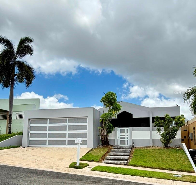 A single-story house with a gray exterior, a multi-pane garage door, and a front staircase — Calle 5 PARQUE SAN MIGUEL UNIT H-8, BAYAMON, PR